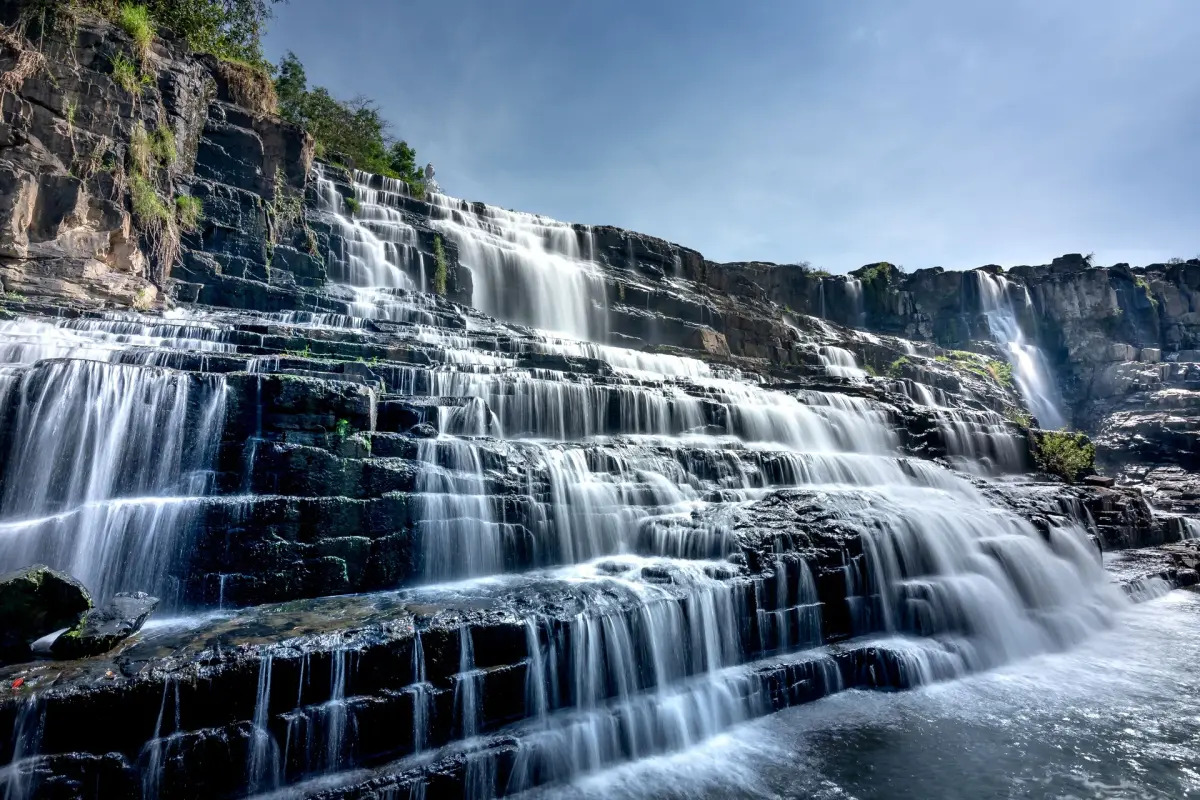 Crystal clear water flowing over rocky cascades at the Akchour Waterfalls in Morocco